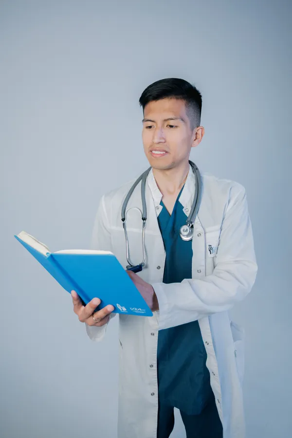 doctor holding blue book
